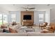 Well-lit living room featuring a modern entertainment area, comfortable seating, and neutral tones at 7054 Rosy Sky Ave, Orlando, FL 32829