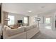 Bright living room featuring a large, comfortable sectional sofa and view through large windows at 7054 Rosy Sky Ave, Orlando, FL 32829