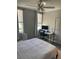 Bright bedroom features a bed, desk, and crib, showcasing a versatile space with ample natural light at 770 Siena Palm Dr # 201, Kissimmee, FL 34747