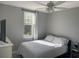 Bright bedroom with natural light featuring a ceiling fan, and soft bedding at 770 Siena Palm Dr # 201, Kissimmee, FL 34747