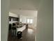 Open-concept living room adjacent to the kitchen with natural light and wood-look flooring at 777 Orchid Grove Blvd, Davenport, FL 33837