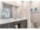 Bright bathroom with double vanity, modern fixtures, and contemporary artwork at 7770 Sandy Ridge Dr # 110, Reunion, FL 34747