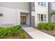 Condo entrance featuring building number, sidewalk, and landscaped bushes at 7770 Sandy Ridge Dr # 110, Reunion, FL 34747