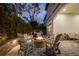 Backyard patio with outdoor fireplace, grill, and comfortable seating at dusk at 8125 Via Vittoria Way, Orlando, FL 32819