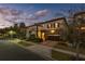 Beautiful home with a stone facade, two-car garage, a manicured lawn, and street view at 8125 Via Vittoria Way, Orlando, FL 32819