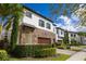 Charming home featuring a stone accent, two-car garage, and meticulously landscaped front yard at 8125 Via Vittoria Way, Orlando, FL 32819