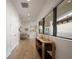 Hallway with wood floors, natural light, and console table under a large window at 8125 Via Vittoria Way, Orlando, FL 32819