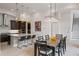 Bright and airy living space featuring a kitchen island, pendant lights, and an open dining area at 8125 Via Vittoria Way, Orlando, FL 32819