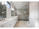 Modern main bathroom with dual sinks, quartz counters, and glass enclosed shower at 8125 Via Vittoria Way, Orlando, FL 32819