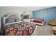 Bright bedroom with two beds, a dresser with TV, and colorful decor at 9030 Sunshine Ridge Loop, Kissimmee, FL 34747