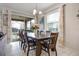 Elegant dining room with seating for eight and view of the screened in pool at 9030 Sunshine Ridge Loop, Kissimmee, FL 34747