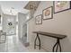 Bright foyer featuring sleek tile flooring, staircase, and a stylish console table at 9030 Sunshine Ridge Loop, Kissimmee, FL 34747