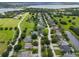 Aerial view of a neighborhood featuring homes, mature trees, and lake in the distance at 932 Classic View Dr, Auburndale, FL 33823