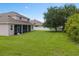 Expansive backyard featuring a well-manicured lawn and a screened porch at 932 Classic View Dr, Auburndale, FL 33823