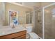 Well-lit bathroom with a shower, toilet, wooden vanity, and a large mirror at 932 Classic View Dr, Auburndale, FL 33823