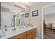 Inviting bathroom with dual sinks, a large mirror, and ample cabinet space at 932 Classic View Dr, Auburndale, FL 33823