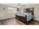 Cozy bedroom featuring a wooden bed frame, ceiling fan, and natural light at 932 Classic View Dr, Auburndale, FL 33823
