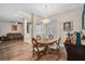 A dining area featuring hardwood floors, a chandelier, and a view of the entryway at 932 Classic View Dr, Auburndale, FL 33823