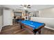 Spacious game room featuring a billiards table, sports bar and hardwood floors at 932 Classic View Dr, Auburndale, FL 33823