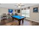Entertaining game room featuring a pool table, wood floors, and ample seating at 932 Classic View Dr, Auburndale, FL 33823