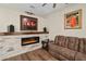 A living room featuring a fireplace, sofa, and an artistic piece of art hanging above at 932 Classic View Dr, Auburndale, FL 33823