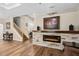 Living room featuring a fireplace, wooden floors, and a staircase at 932 Classic View Dr, Auburndale, FL 33823