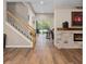 Living room featuring a fireplace, wooden floors, and a staircase at 932 Classic View Dr, Auburndale, FL 33823