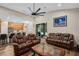 Inviting living room featuring leather sofas, wood floors, and sliding doors to the outside at 932 Classic View Dr, Auburndale, FL 33823