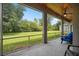 Relaxing screened porch overlooking a large, well-maintained backyard and lush greenery at 932 Classic View Dr, Auburndale, FL 33823