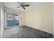 Bedroom with carpet floors, ceiling fan, and sliding door to the balcony at 127 Whitecaps Cir, Maitland, FL 32751