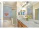 Bathroom featuring double sinks, tub, and glass-enclosed shower at 1311 Travertine Ter, Sanford, FL 32771