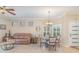 Cozy dining area with elegant chandelier, and comfortable leather sofa at 1311 Travertine Ter, Sanford, FL 32771