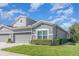 Charming gray two-story home featuring a well-manicured lawn and a two-car garage at 1311 Travertine Ter, Sanford, FL 32771