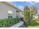 Attractive gray home with manicured hedges and a well-maintained walkway at 1311 Travertine Ter, Sanford, FL 32771