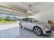 Spacious two-car garage with a silver SUV parked inside, showcasing the home's exterior at 1311 Travertine Ter, Sanford, FL 32771
