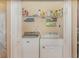 Well-organized laundry closet with a Maytag washer, Whirlpool dryer, and wire shelving for storage at 1311 Travertine Ter, Sanford, FL 32771