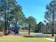 Colorful playground featuring swings and climbing structures for to enjoy under a clear sky at 1311 Travertine Ter, Sanford, FL 32771