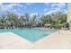 Large community swimming pool featuring sunbathing chairs and tables under a sunny sky at 1311 Travertine Ter, Sanford, FL 32771