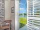 A chair faces a sliding glass door offering serene water views with a fountain and lush greenery at 1311 Travertine Ter, Sanford, FL 32771