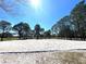 Outdoor sand volleyball court with nets stretched between tall pine trees under a bright blue sky at 1311 Travertine Ter, Sanford, FL 32771