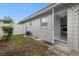 Small backyard with door leading into the house at 1407 Dunsany Ave, Orlando, FL 32806