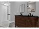 Bathroom featuring double vanity with wood drawers, dual mirrors, and designer tile at 1407 Dunsany Ave, Orlando, FL 32806