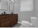 Modern bathroom featuring double vanity, two mirrors, and new toilet at 1407 Dunsany Ave, Orlando, FL 32806