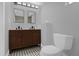 Bathroom featuring double vanity, two mirrors, and new toilet at 1407 Dunsany Ave, Orlando, FL 32806