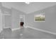 Bright bedroom with bathroom access features tiled floor and window letting in natural light at 1407 Dunsany Ave, Orlando, FL 32806