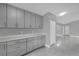 Well-lit kitchen features gray cabinetry, quartz countertops, and modern hardware at 1407 Dunsany Ave, Orlando, FL 32806