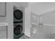 Modern laundry area with stacked washer and dryer, conveniently located near living spaces at 1407 Dunsany Ave, Orlando, FL 32806