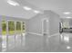 Bright living room featuring sliding glass doors to the backyard and sleek tile flooring throughout at 1407 Dunsany Ave, Orlando, FL 32806