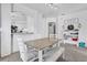 Dining area featuring a wood table with white chairs and an open floor plan at 142 Villa Di Este Ter # 204, Lake Mary, FL 32746