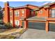 Close up on an orange painted townhouse with an attached garage at 142 Villa Di Este Ter # 204, Lake Mary, FL 32746